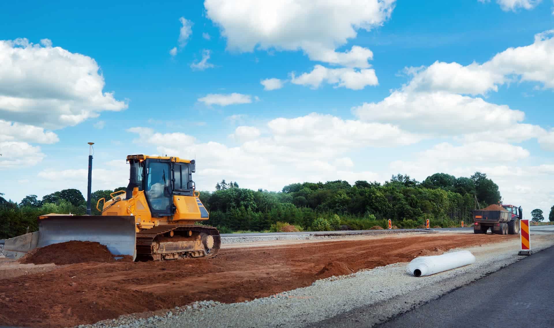 Bull Dozer Pushing Dirt on a Road Construction Project